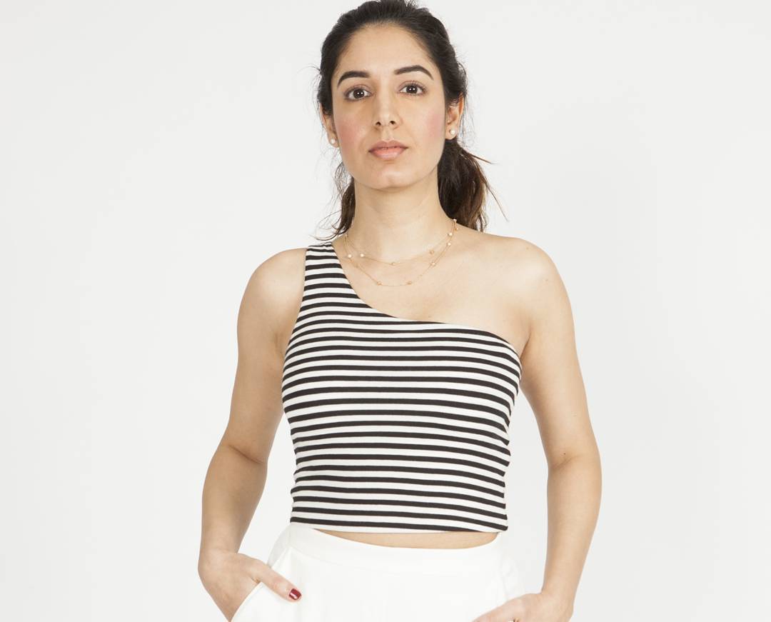 Full-length editorial studio portrait with fresh natural makeup and a clean camera-ready finish