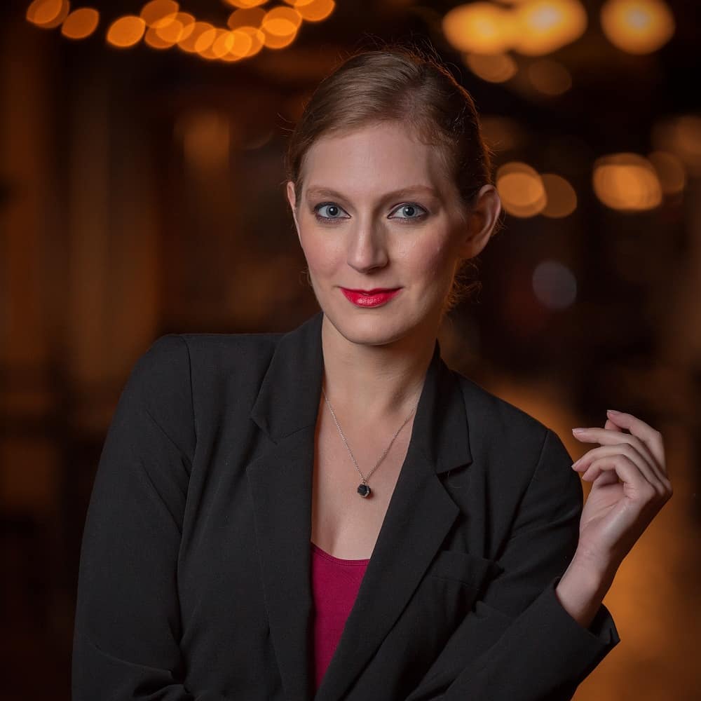Corporate headshot with polished skin, neutral eyes and a bold red lip in a black blazer