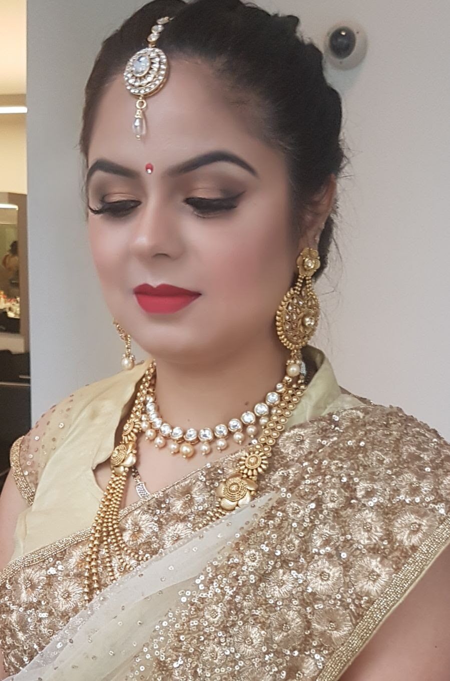 South Asian bridal look with sculpted eyes, glowing skin and traditional gold jewellery