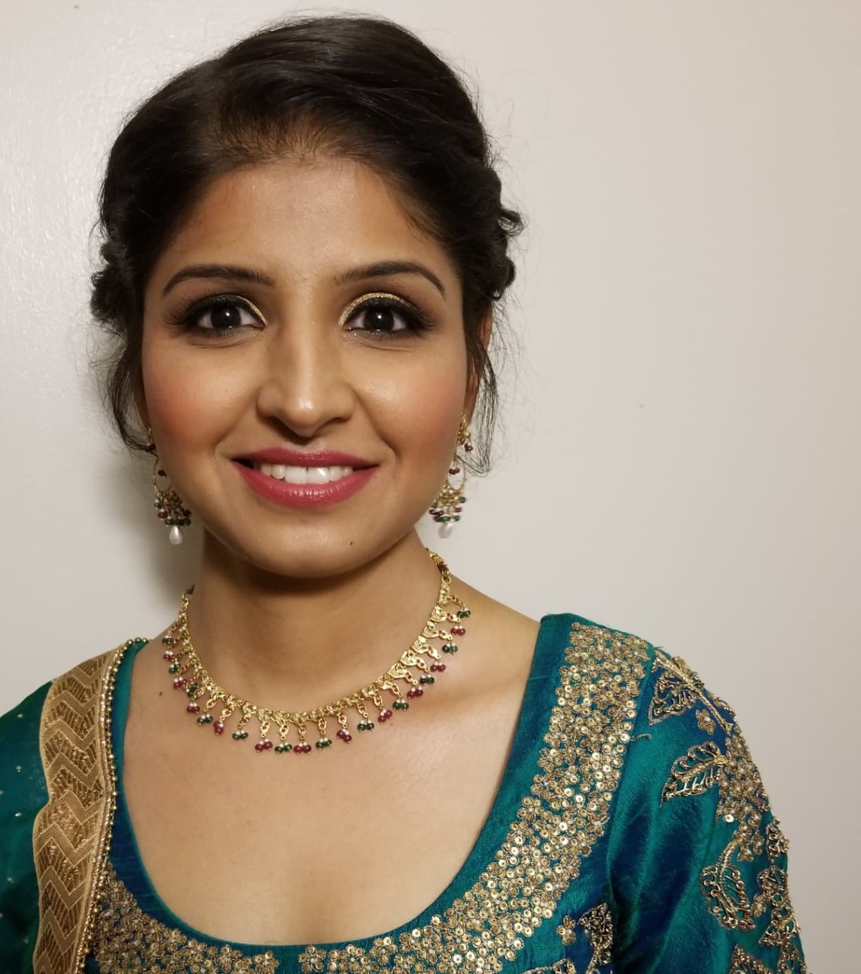 Party glam with gold shimmer eyes, winged liner and a rose lip, styled with traditional jewellery