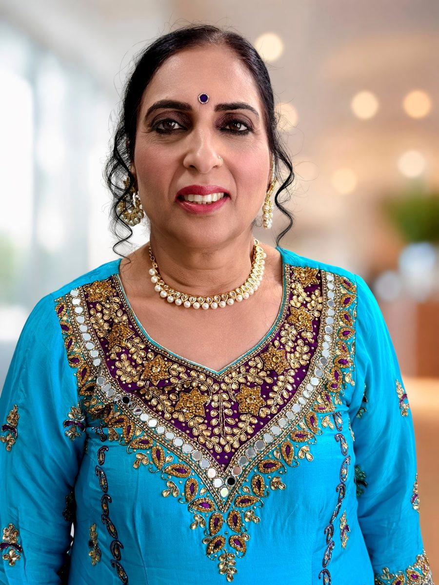 Mother of the groom event makeup with a bronze smoky eye, warm blush and a berry lip, styled with an updo and pearl jewellery
