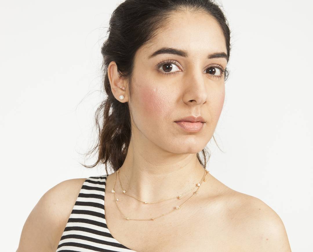 Editorial studio portrait with natural skin finish, soft blush and a nude lip