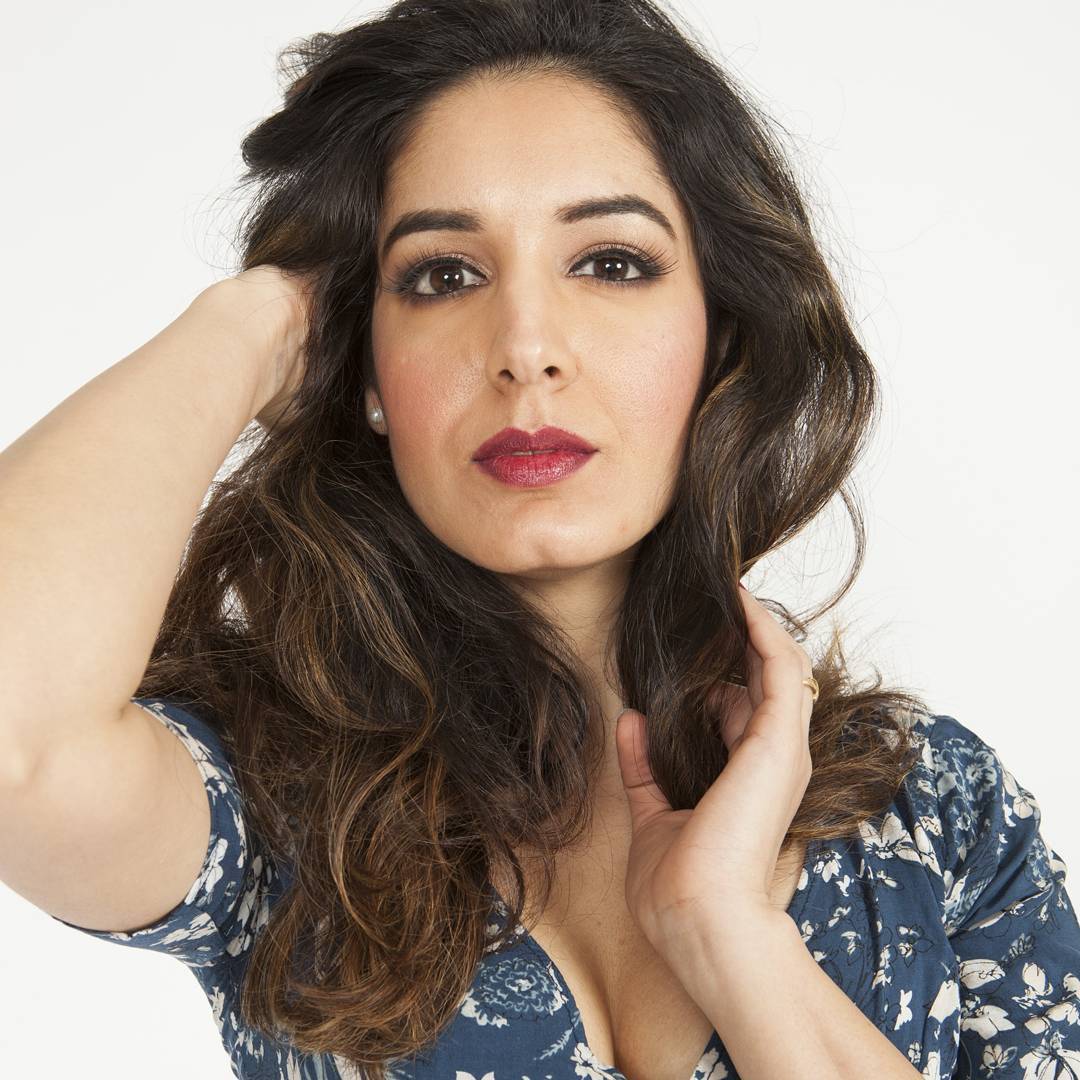 Close-up fashion beauty portrait with soft smoky eyes, radiant skin and a berry lip