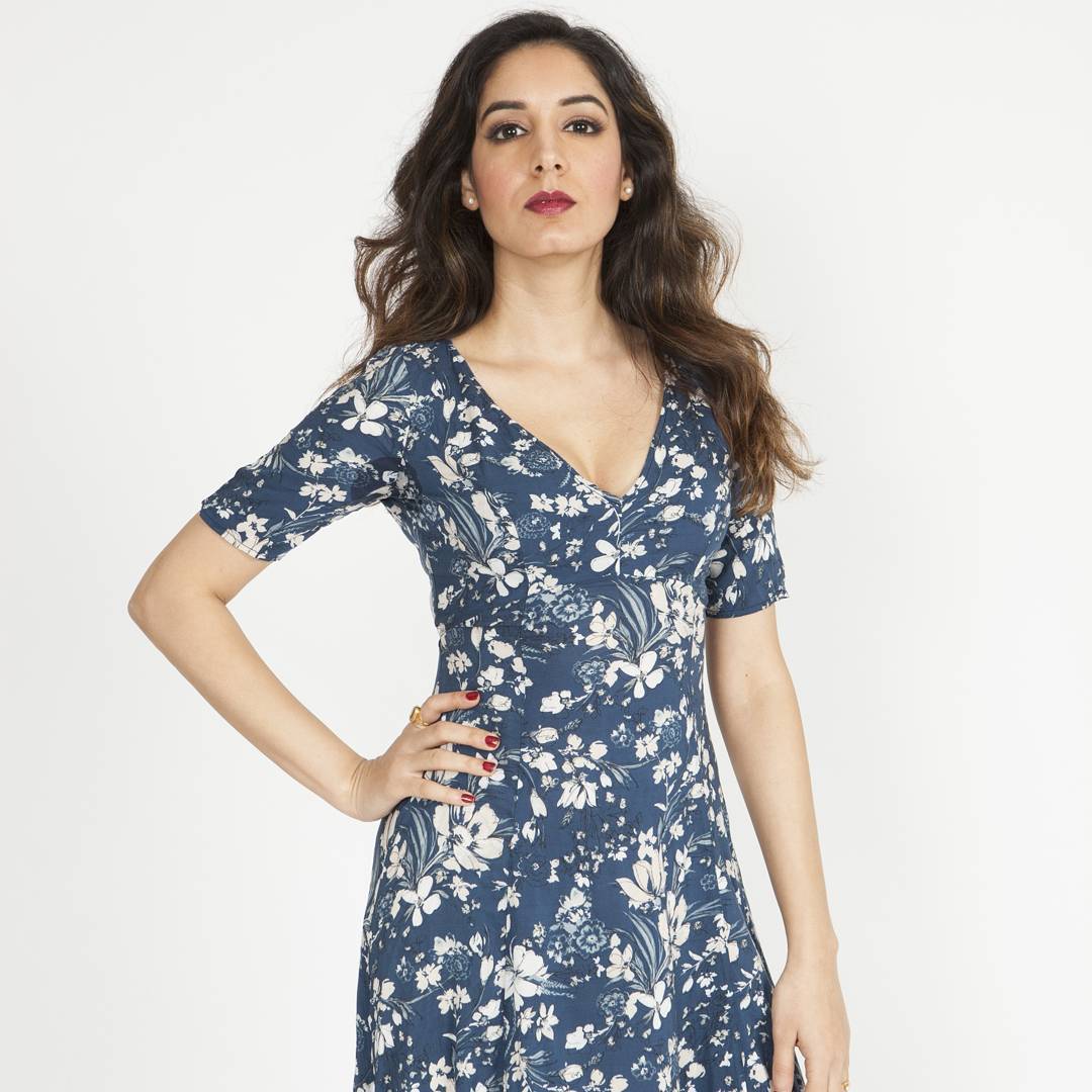 Studio fashion portrait with defined brows, soft glam eyes and a bold berry lip