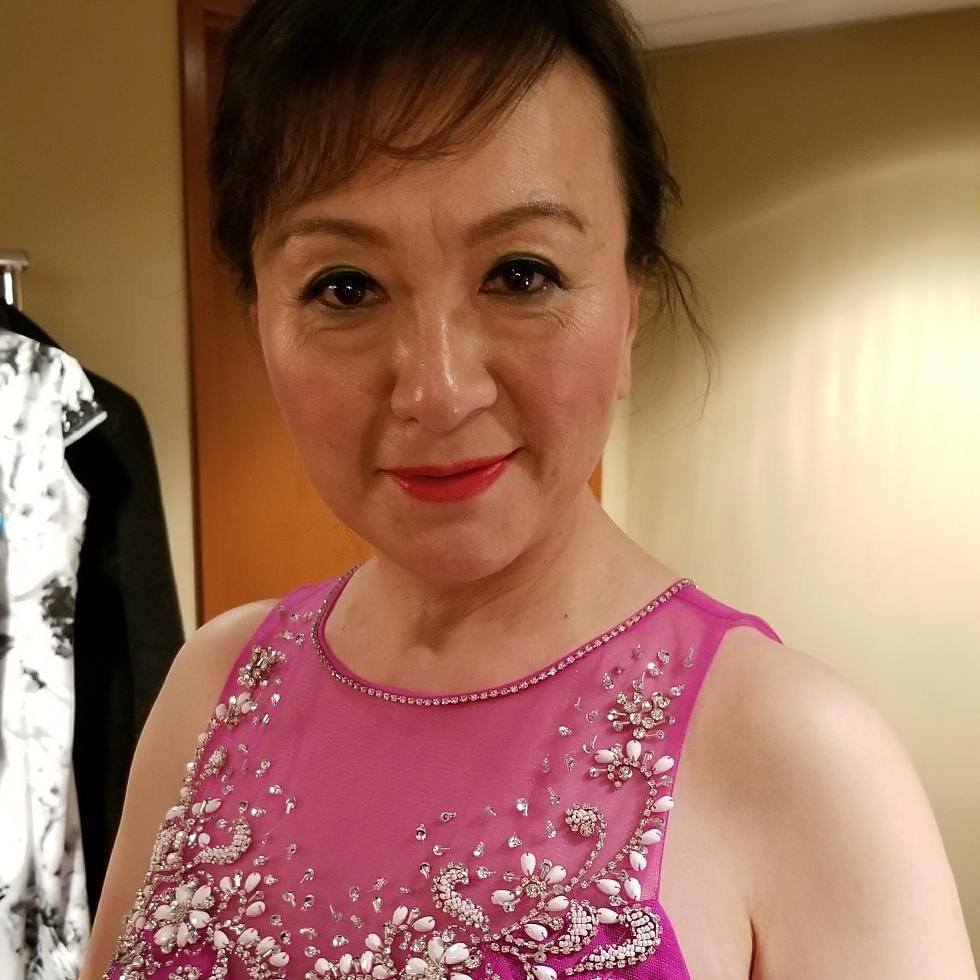 Senior fashion show makeup with elegant liner, warm blush and a classic red lip in a magenta gown