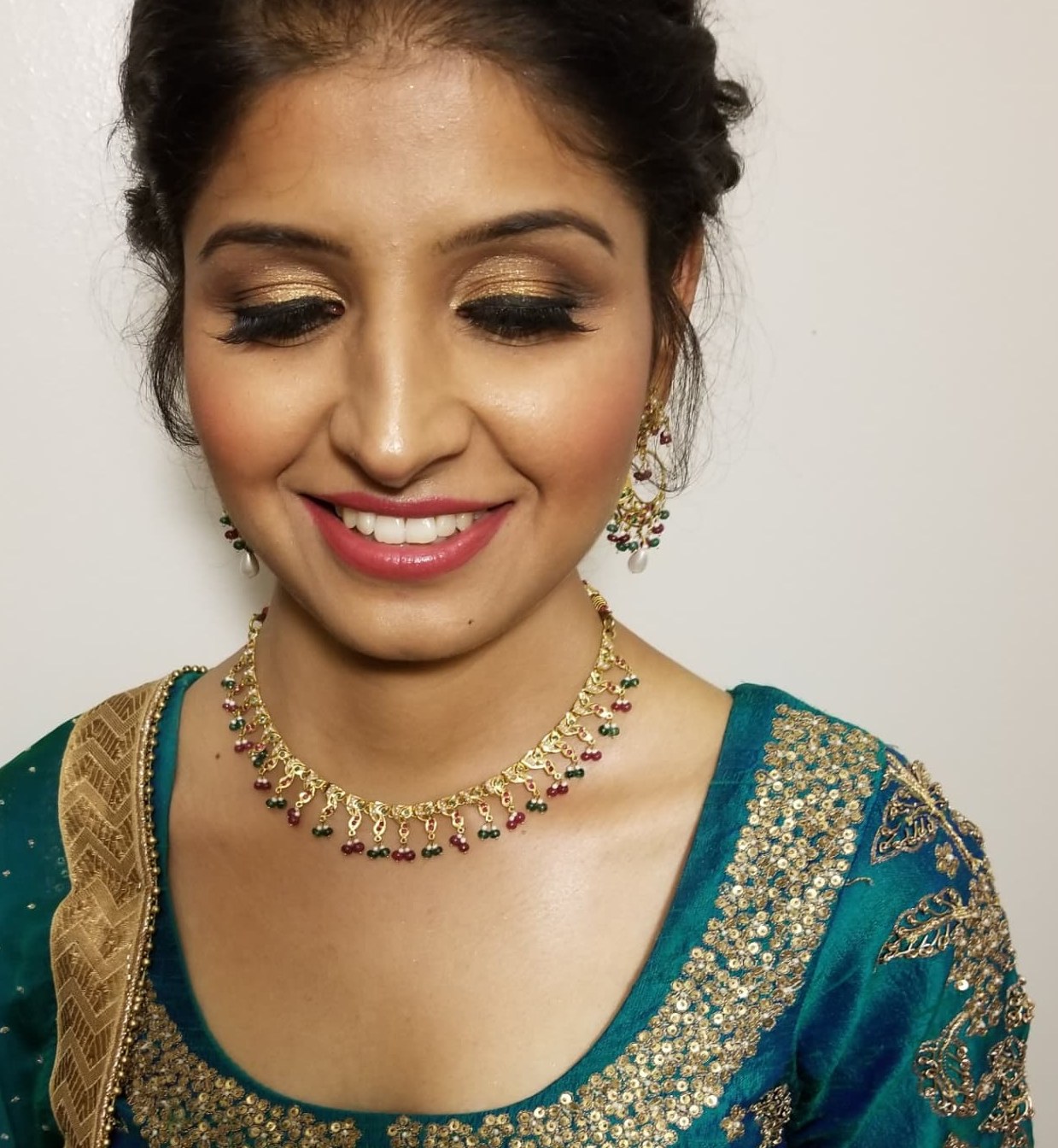 Close-up of gold and bronze shimmer eyeshadow with full lashes and glowing skin