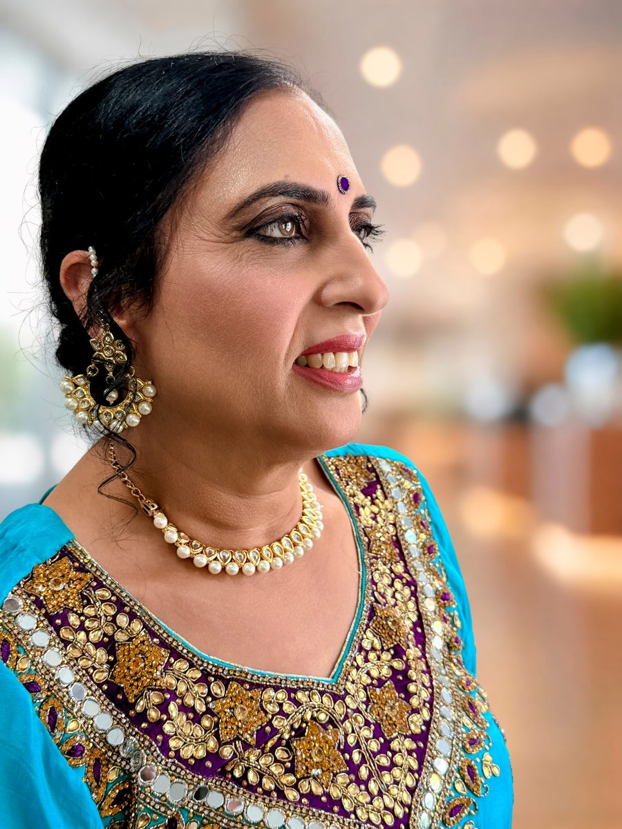 Three-quarter portrait of mother-of-the-groom makeup with a deep smoky eye, sculpted cheeks and a rose-berry lip